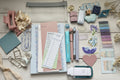 Collection of stationery items including notebooks, pens, and decorative elements