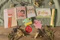 Collection of stationery items including notebooks, stickers, and a pen.